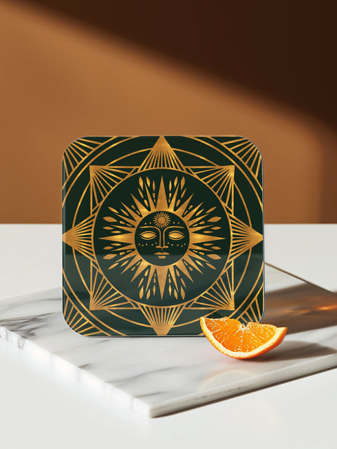 A set of four square coasters with a glossy finish, featuring celestial gold designs on a deep forest green background. Each coaster showcases a unique motif: a stylized sun with a serene face, a crescent moon with a star, a triple moon symbol with botanical elements, and a radiant sunburst. The intricate gold linework creates an art deco-inspired, mystical aesthetic. Made from durable materials, these coasters blend elegance with celestial charm.